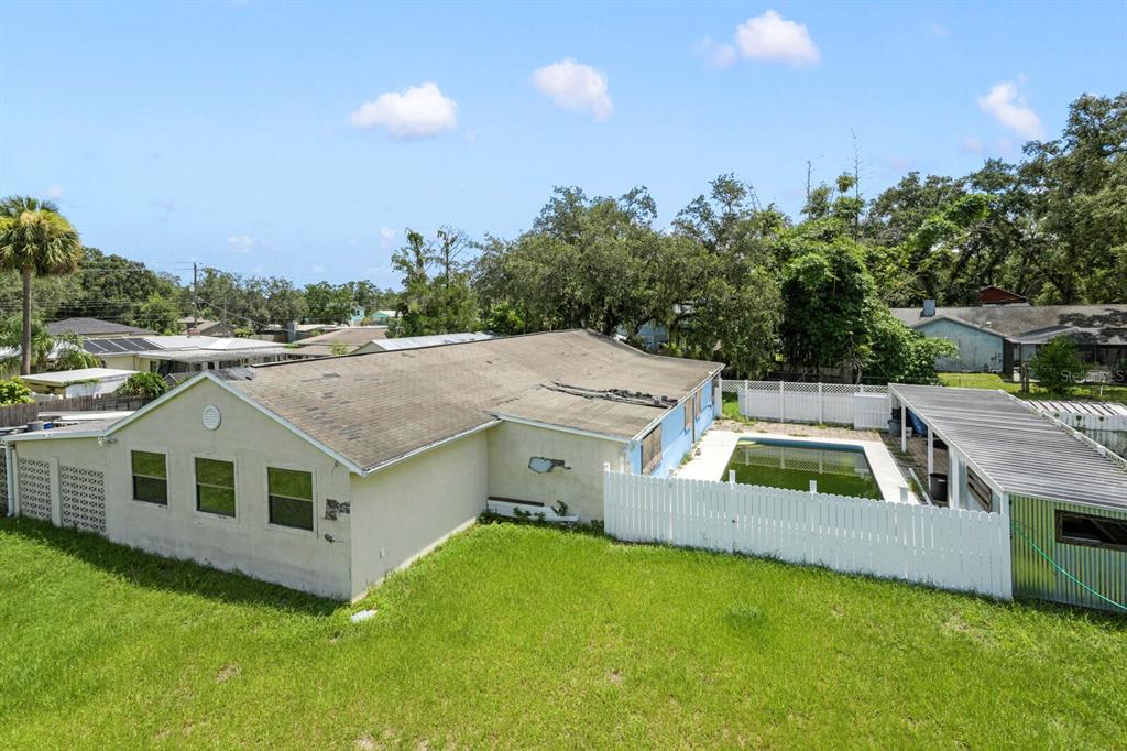 An aerial view of a house with a backyard pool and a detached garage — 11735 MARJORY AVENUE, TAMPA, FL