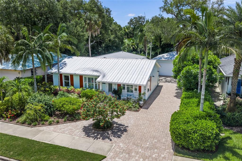 An aerial view of a single-story house with a metal roof and a paved driveway — 2440 ARLINGTON STREET, SARASOTA, FL
