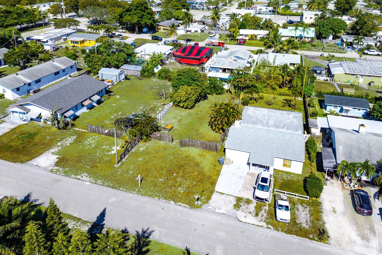 An aerial view shows a residential lot with a house, driveway, and surrounding neighborhood properties — 1073 Florence Road, Lake Worth FL 33462, LAKE WORTH, FL