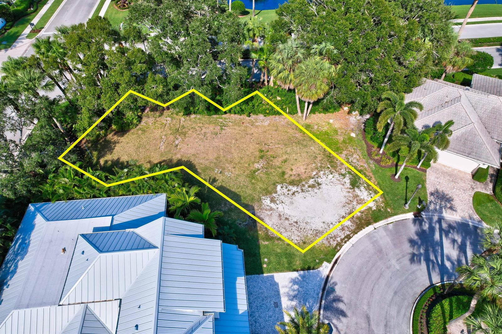 An aerial view shows a vacant, irregularly shaped residential lot outlined in yellow — 187 Birkdale Lane, Jupiter FL 33458, JUPITER, FL