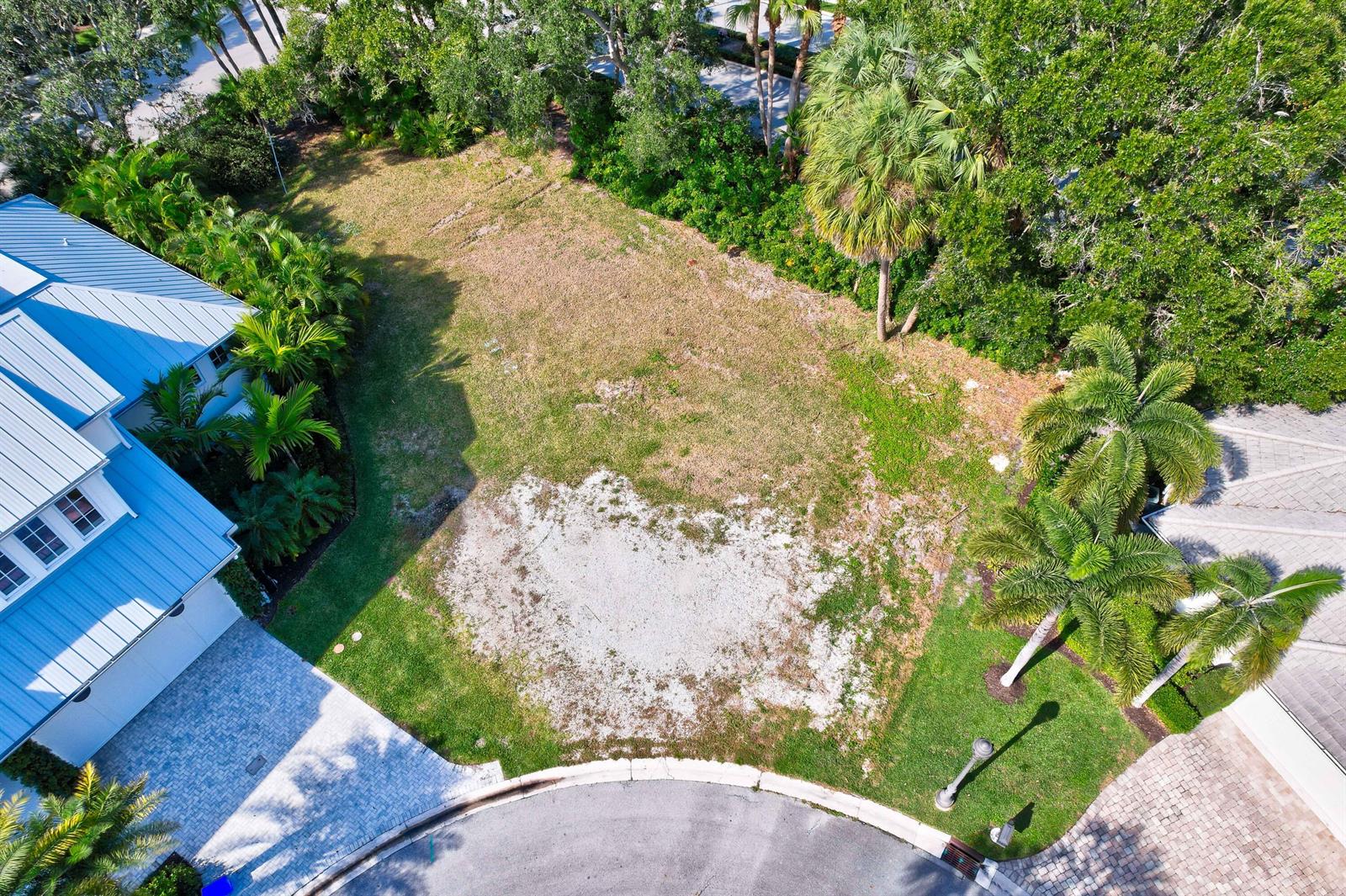 An aerial view of a vacant residential lot situated between two houses on a cul-de-sac — 187 Birkdale Lane, Jupiter FL 33458, JUPITER, FL