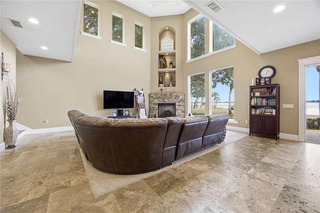 An entryway features a wooden door with diagonal side panels, a large cabinet, and bench — 15389 SE 105TH TERRACE ROAD, SUMMERFIELD, FL
