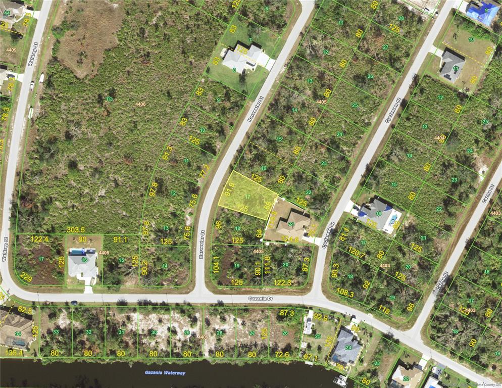 This is an aerial map showing residential lots, streets, and a waterway — 9314 HARVESTER STREET, PORT CHARLOTTE, FL