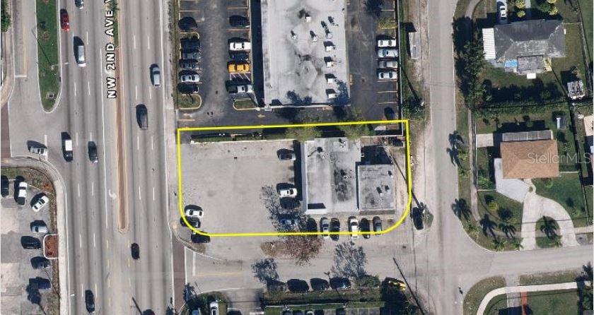 This aerial view shows a commercial building with a parking lot outlined in yellow — 19301 NW 2ND AVENUE, MIAMI, FL