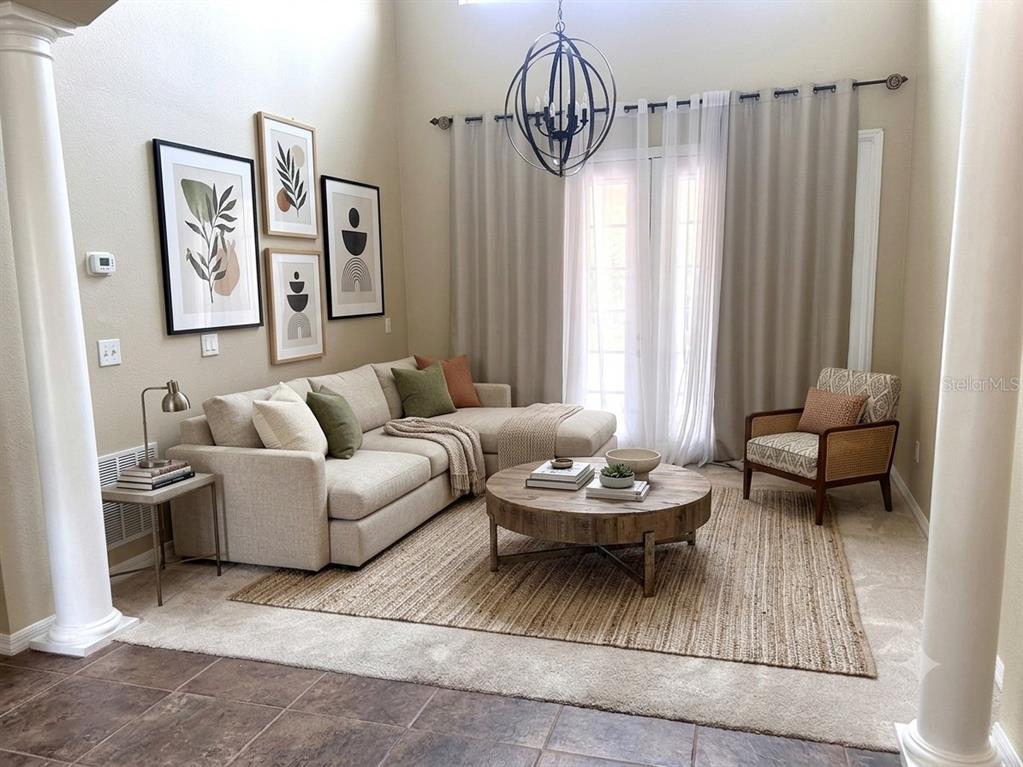 A living room features a sectional sofa, a round wooden coffee table, and framed wall art — 11773 BELLA MILANO COURT, WINDERMERE, FL