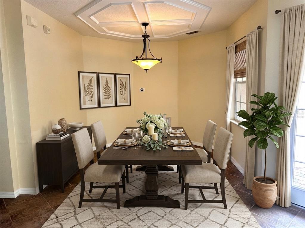 A dining room features a dark wood table, upholstered chairs, and a coffered ceiling — 11773 BELLA MILANO COURT, WINDERMERE, FL