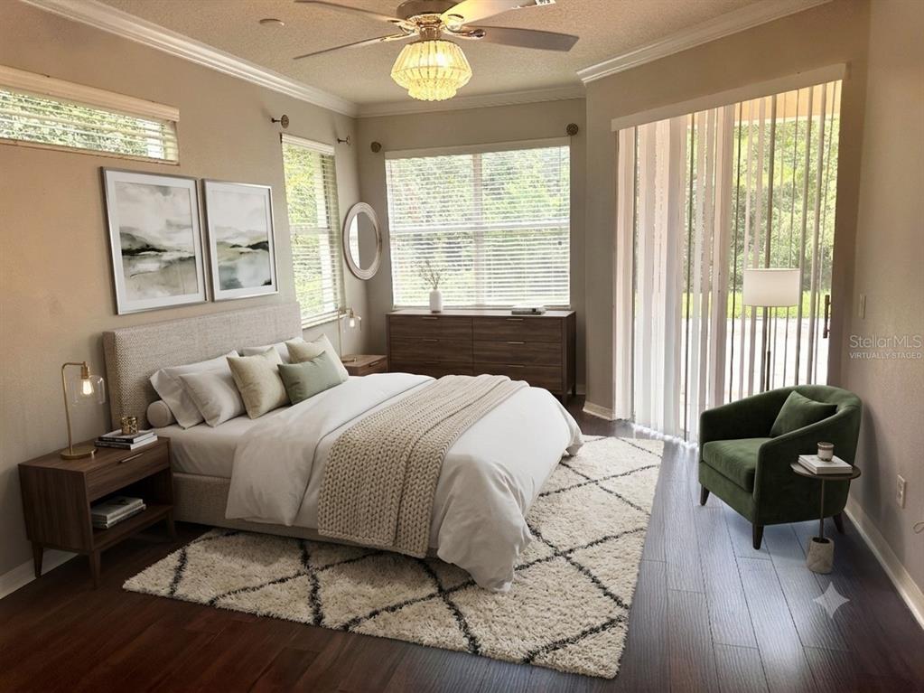 This bedroom features a bed, a green armchair, a dresser, and a large sliding glass door — 11773 BELLA MILANO COURT, WINDERMERE, FL