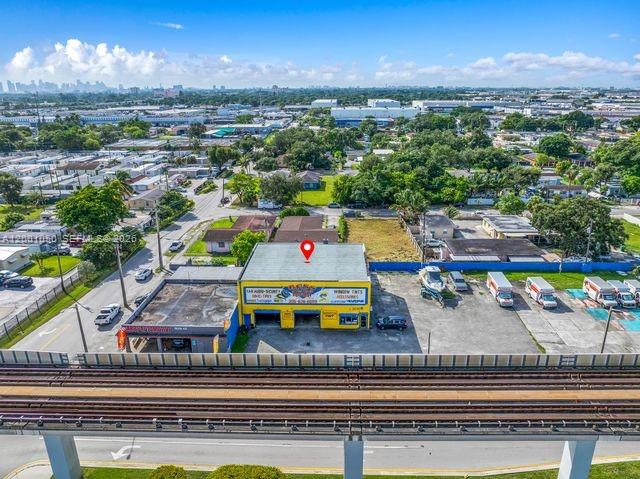 An aerial view shows a commercial building with a red map pin on its roof — 3030 NW 79th St, Miami FL 33147, MIAMI, FL