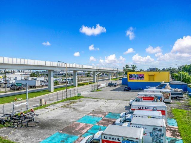 An elevated train track runs above a parking lot filled with U-Haul trucks — 3030 NW 79th St, Miami FL 33147, MIAMI, FL