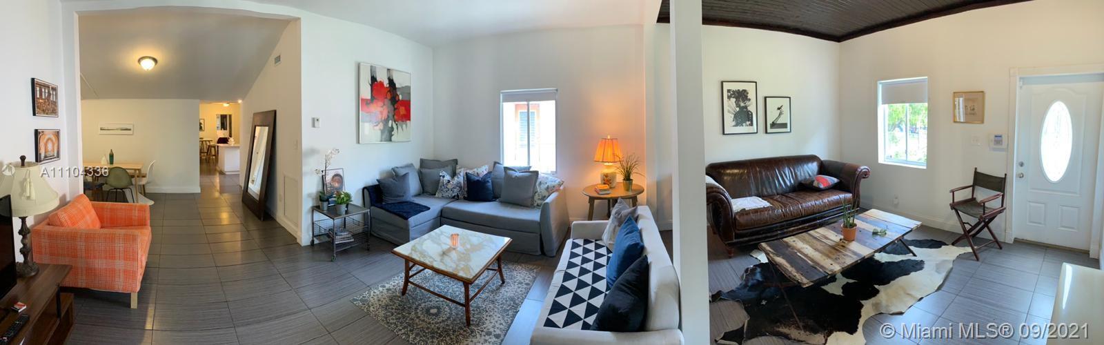 A panoramic view of a living area featuring tiled floors, two sofas, and a coffee table — 68 NW 45th St, Miami FL 33127, MIAMI, FL