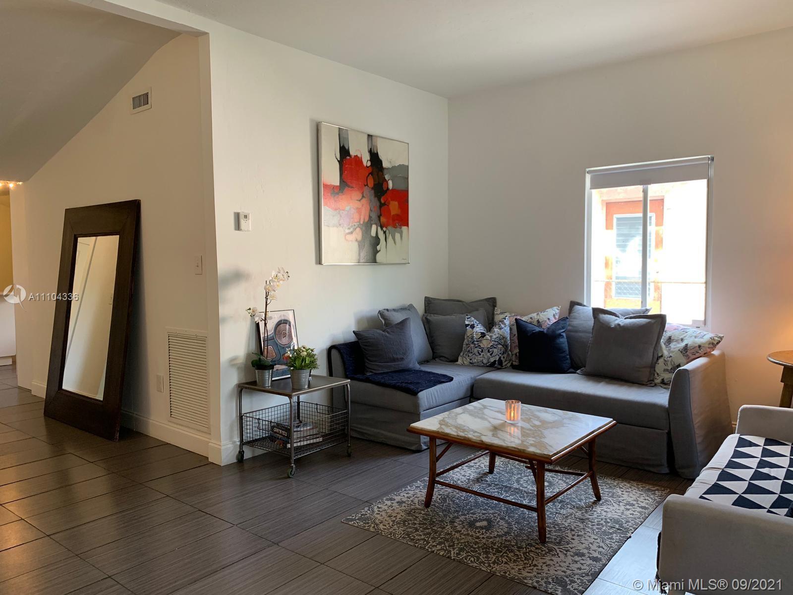 A living room features a gray sectional sofa, a marble coffee table, and a floor mirror — 68 NW 45th St, Miami FL 33127, MIAMI, FL