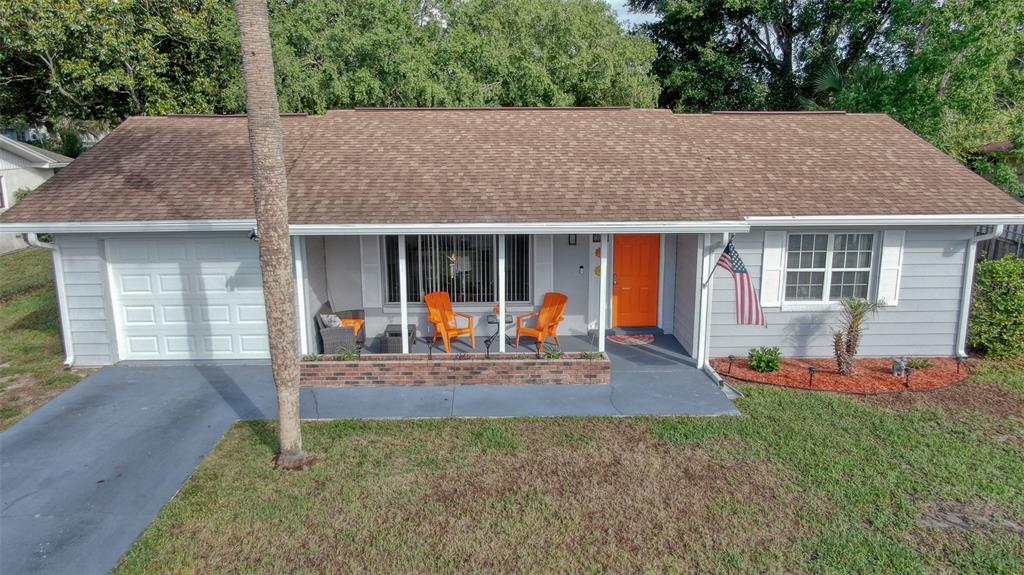 A single-story gray house with a brown roof, orange front door, and a front porch — 478 WATER COURT, OCALA, FL