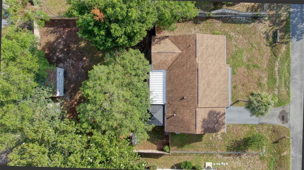 An aerial view shows a house with a brown roof, a backyard, and large trees — 478 WATER COURT, OCALA, FL