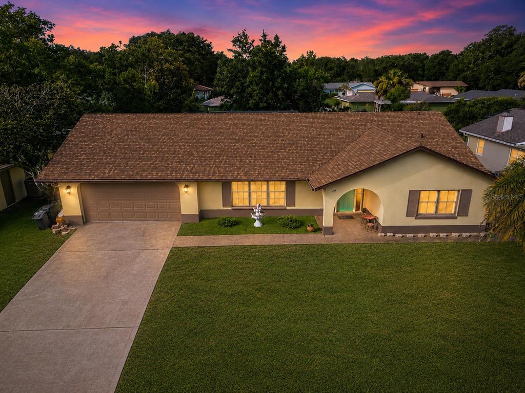 An aerial view of a single-story house with a brown roof and a large lawn — 10 BLACKBURN PLACE, PALM COAST, FL