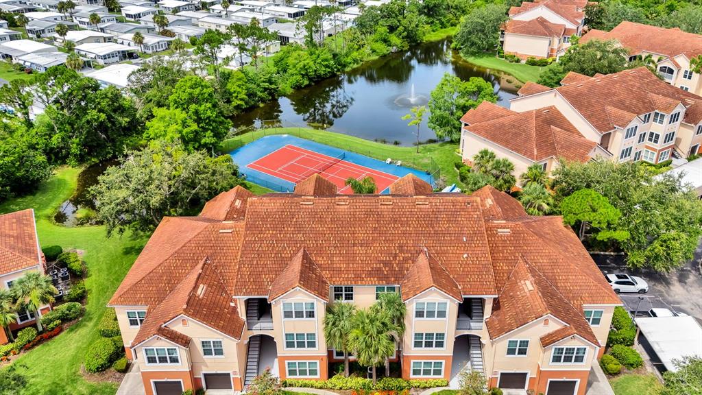 A kitchen features white cabinets, granite countertops, stainless steel appliances, and a breakfast bar — 4142 CENTRAL SARASOTA PARKWAY UNIT 1426, SARASOTA, FL