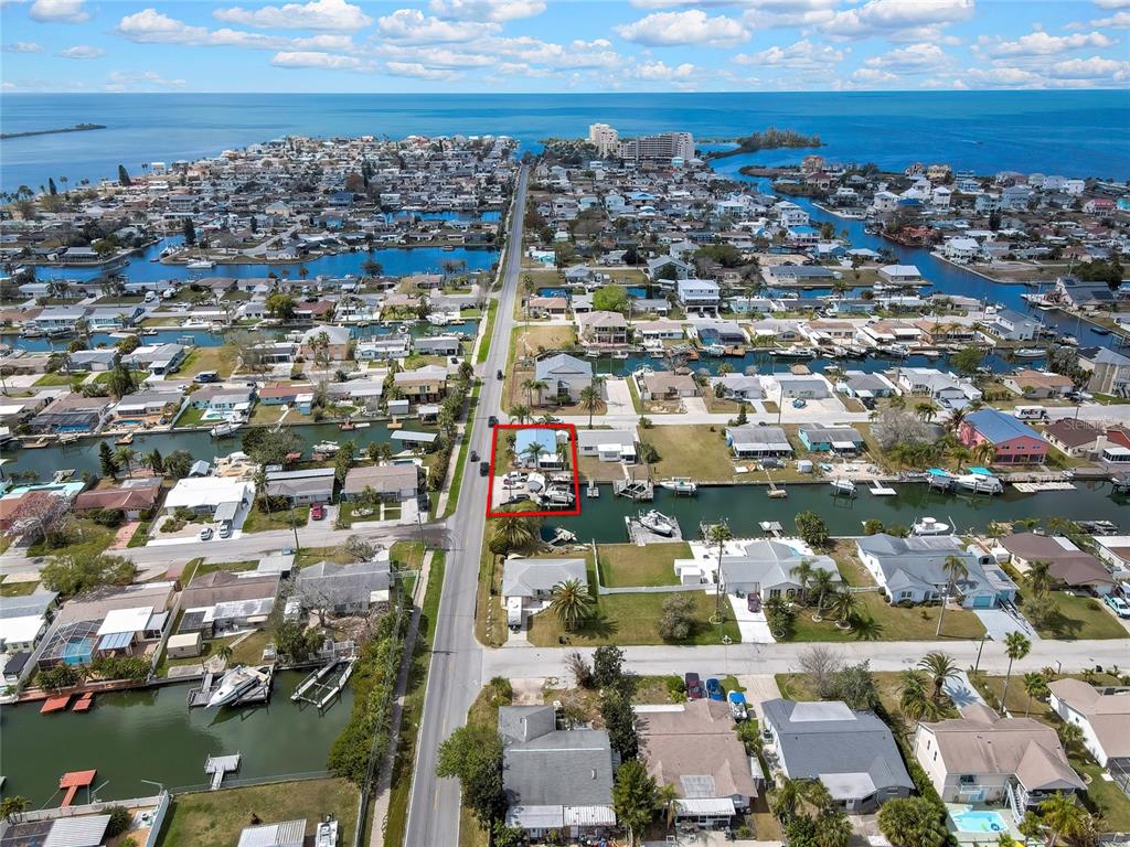 An aerial view shows a waterfront house with a red outline along a canal — 6601 SEA RANCH DRIVE, HUDSON, FL