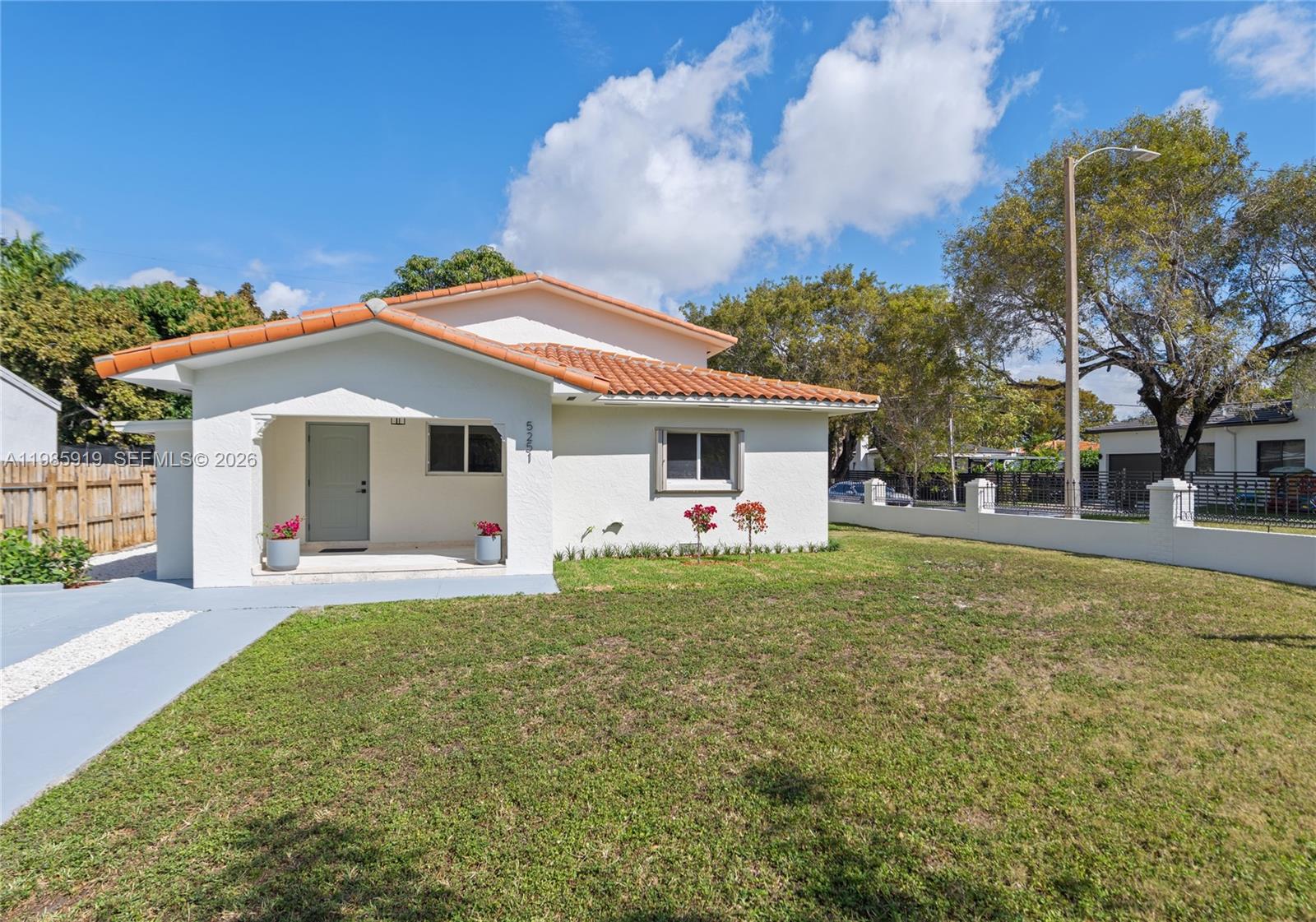 A single-story white house features a terracotta tile roof and a front porch — 5251 SW 6th St, Miami FL 33134, MIAMI, FL