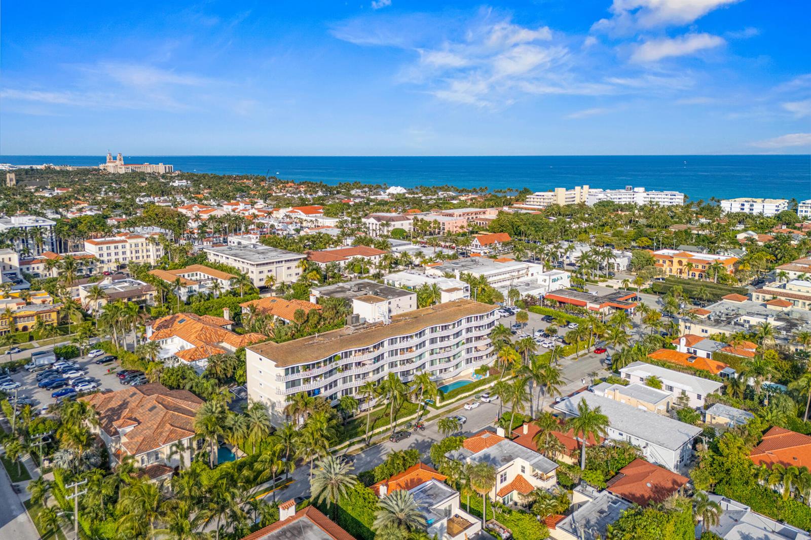 An aerial view of a multi-story apartment building surrounded by palm trees and residential homes — 227 Australian Avenue # 2c, Palm Beach FL 33480, PALM BEACH, FL
