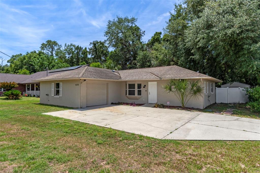 A single-story house with a beige exterior, a one-car garage, and a concrete driveway — 6236 W PINEDALE CIRCLE, CRYSTAL RIVER, FL