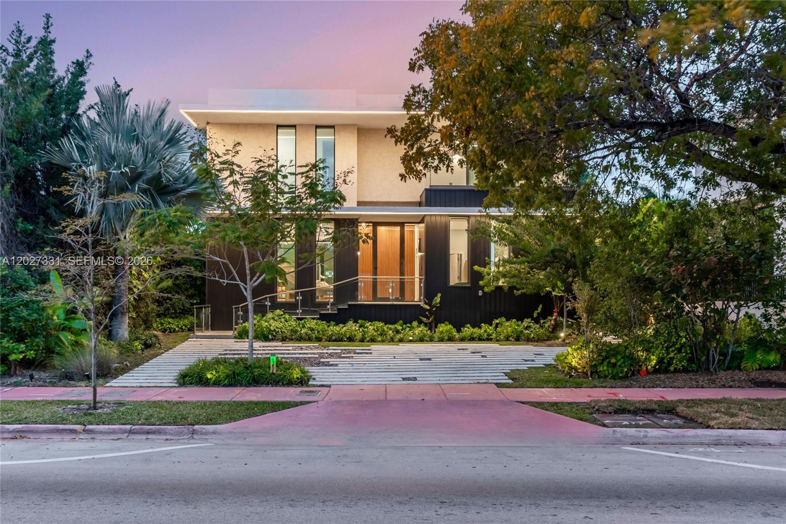 A modern two-story house with a dark facade, glass entry, and horizontal concrete driveway pavers — 4354 Alton Rd, Miami Beach FL 33140, MIAMI BEACH, FL