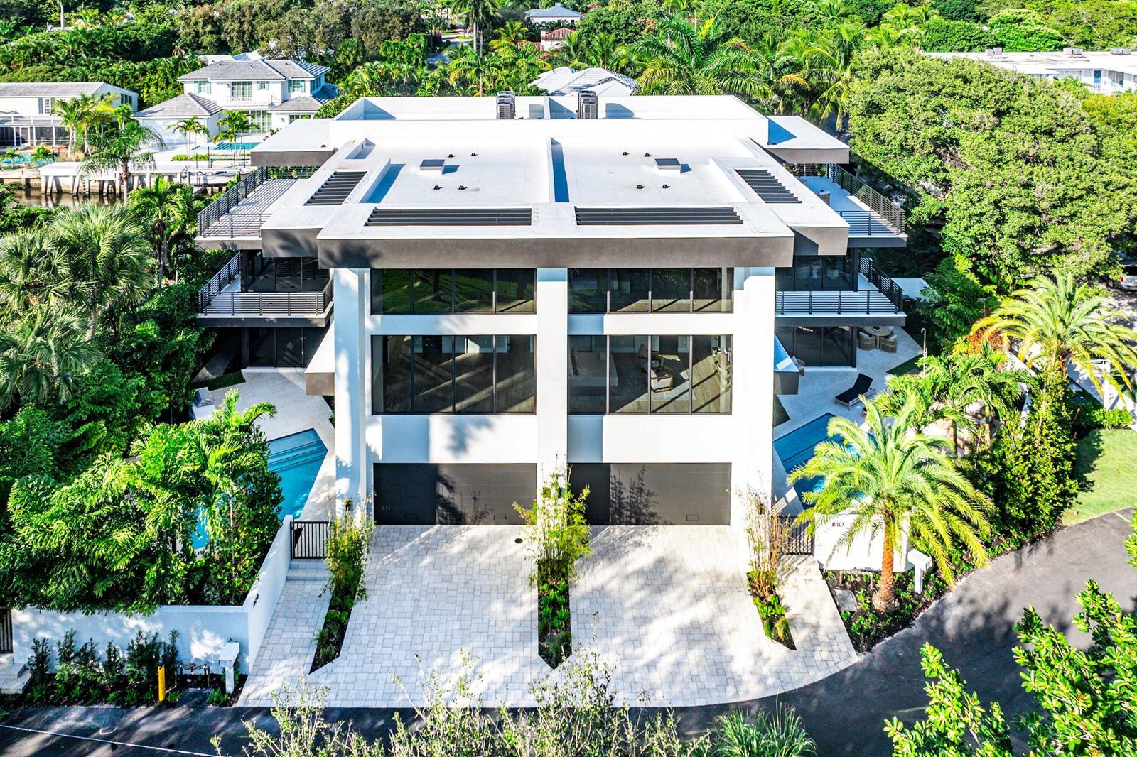 An aerial view of a modern three-story home with a flat roof and two garages — 810 Andrews Avenue, Delray Beach FL 33483, DELRAY BEACH, FL
