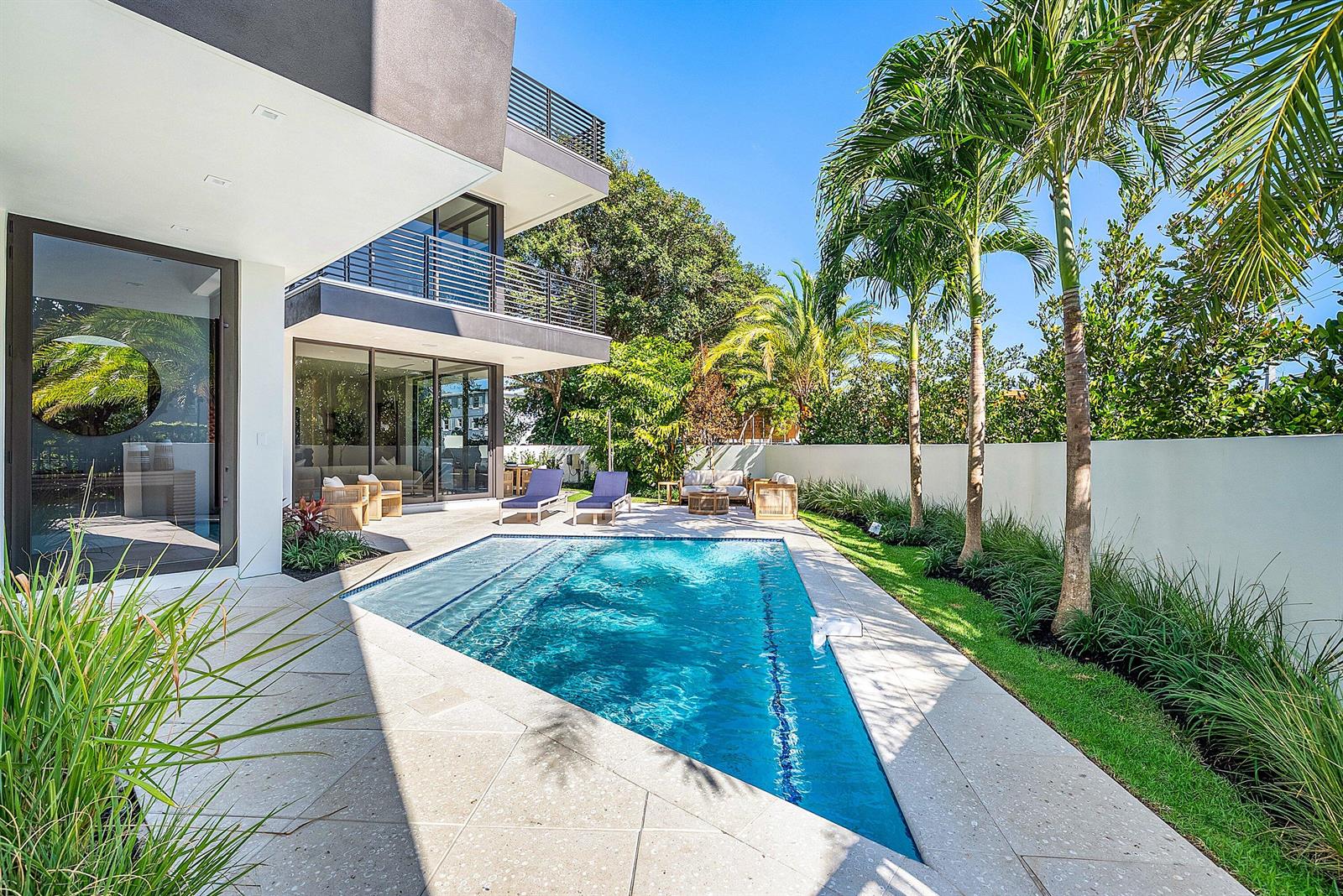 A modern two-story house with a triangular swimming pool, patio, and palm trees — 810 Andrews Avenue, Delray Beach FL 33483, DELRAY BEACH, FL