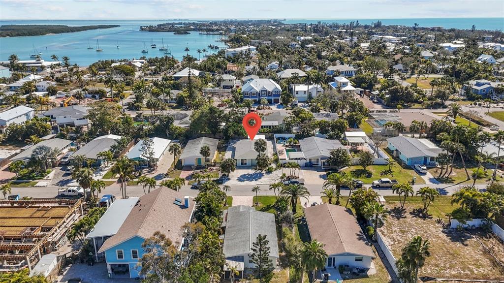 An aerial view shows a residential neighborhood with a red location pin over a house — 690 FOX STREET, LONGBOAT KEY, FL