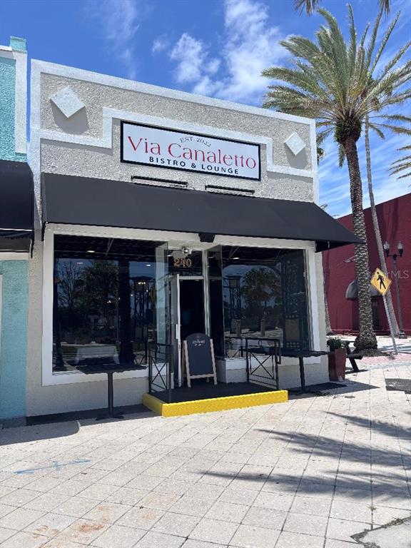 The exterior of a bistro and lounge features a black awning and a glass storefront — 240 S BEACH STREET, DAYTONA BEACH, FL