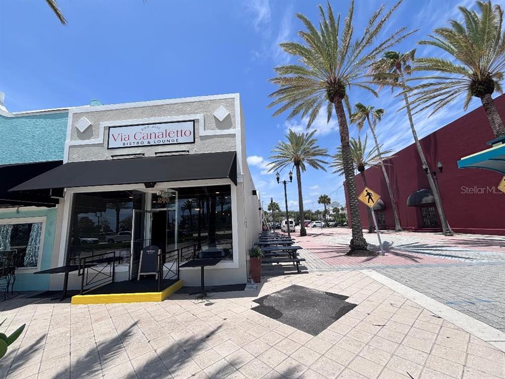 The exterior of a bistro and lounge features a black awning and outdoor seating — 240 S BEACH STREET, DAYTONA BEACH, FL