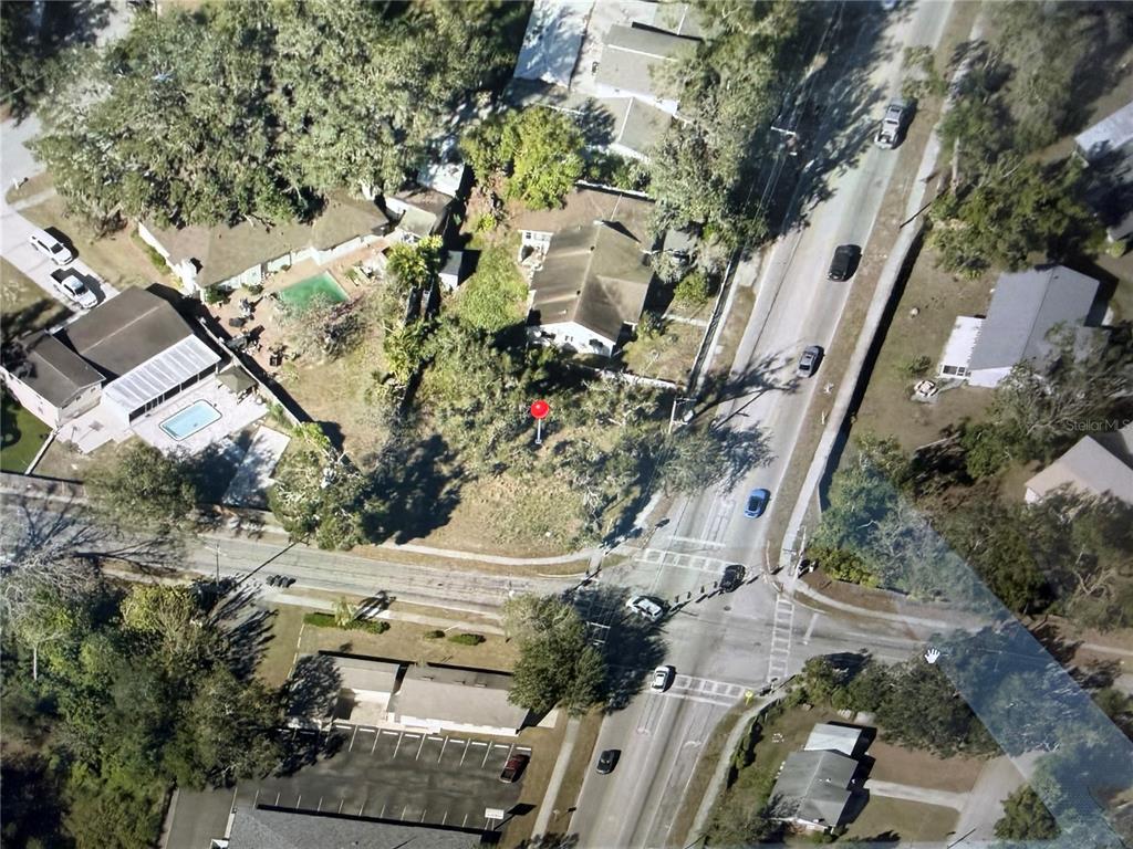 This aerial view shows a vacant lot marked with a red pin near a road — 0 CLAY AVENUE, BRANDON, FL