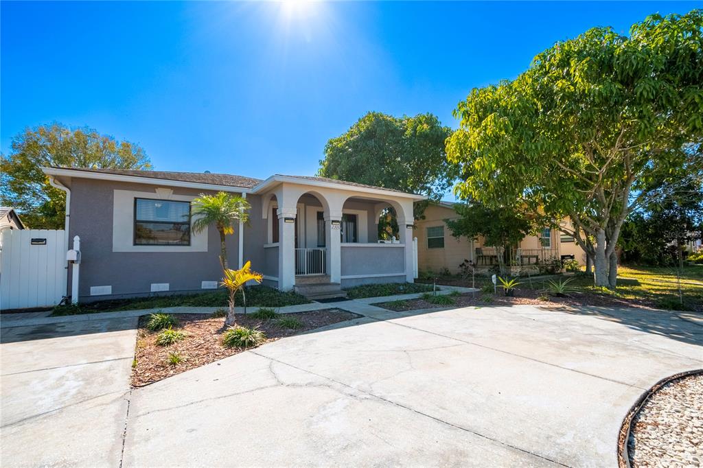 A single-story house with a covered arched porch and a concrete driveway — 2300 37TH AVENUE N, ST PETERSBURG, FL