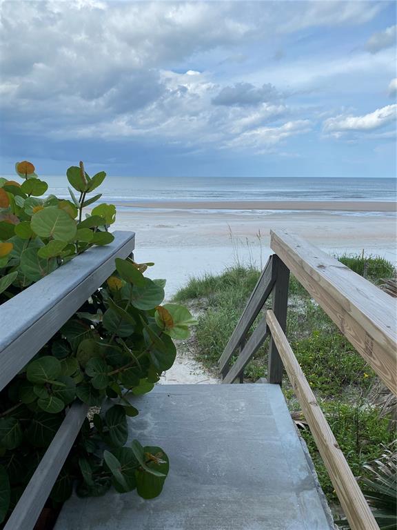A wooden staircase leads down from a dune to a sandy beach and the ocean — 4453 S ATLANTIC AVENUE UNIT 208, PONCE INLET, FL