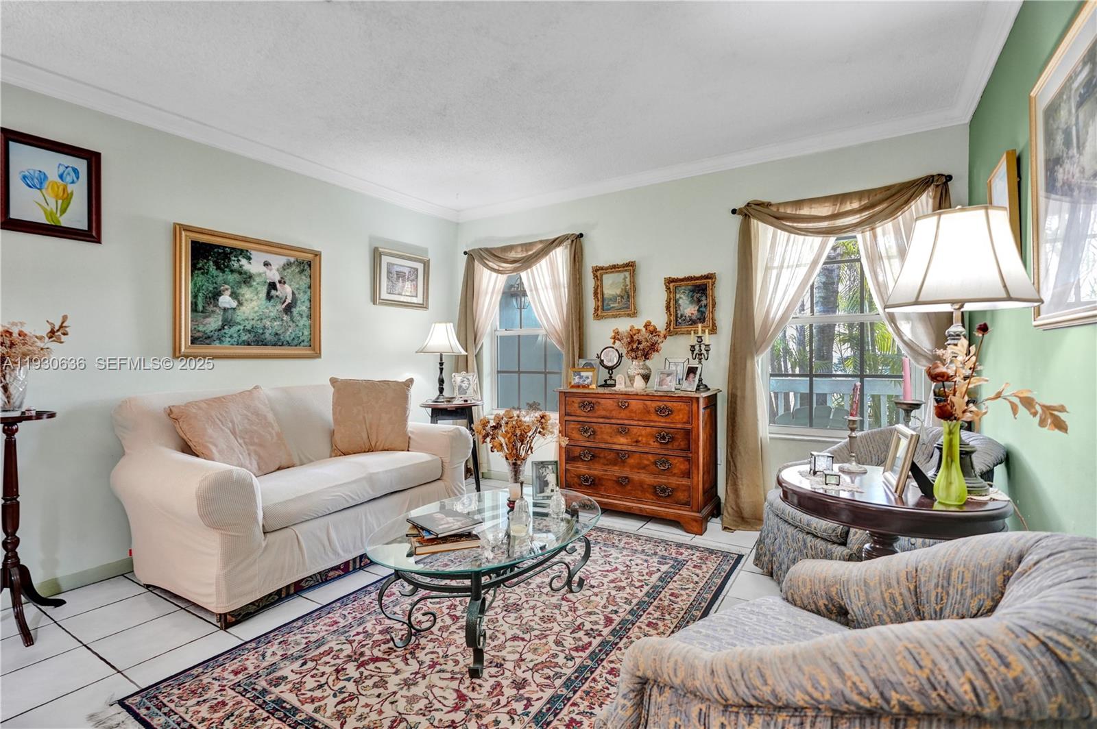 A living room features a white sofa, patterned armchairs, a glass coffee table, and decor — 11728 SW 118th Ter, Miami FL 33186, MIAMI, FL
