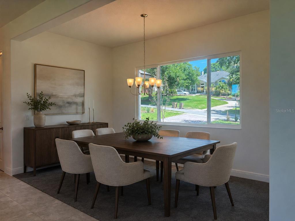 A dining room features a dark wood table, six upholstered chairs, and a large window — 5540 SADDLEBACK COURT, LADY LAKE, FL