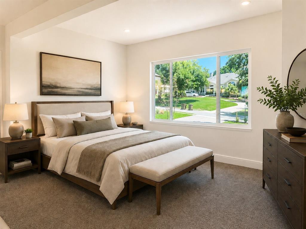 A bedroom features a queen bed, a bench, a dresser, and a large window view — 5540 SADDLEBACK COURT, LADY LAKE, FL