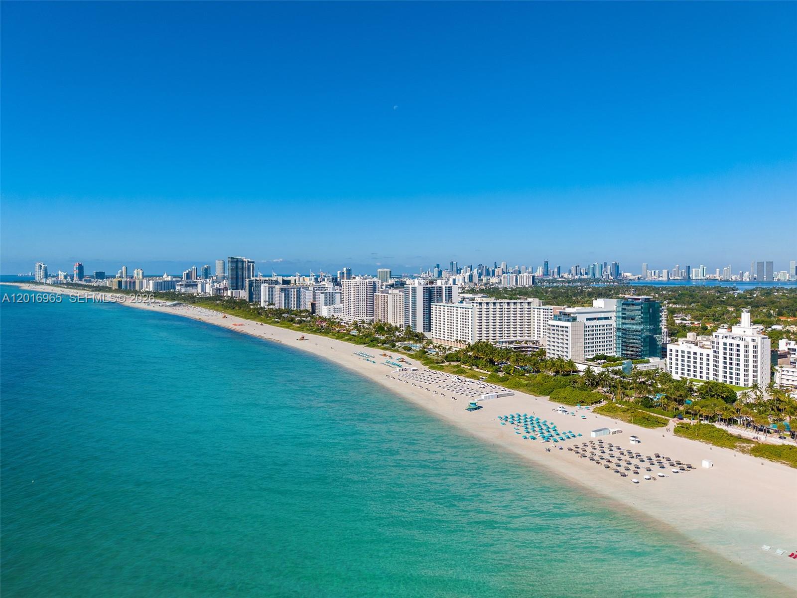 An aerial view of a sandy beach lined with high-rise buildings and turquoise ocean water — 2901 Collins Ave # 901, Miami Beach FL 33140, MIAMI BEACH, FL
