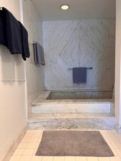 A bathroom features a raised marble soaking tub with a wall-mounted towel rack — 199 Ocean Lane Dr # 903, Key Biscayne FL 33149, KEY BISCAYNE, FL