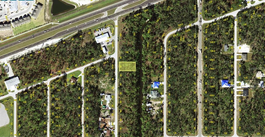 This is an aerial map showing a highlighted vacant lot surrounded by trees and roads — 2062 TEA STREET, PORT CHARLOTTE, FL