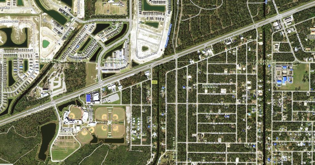 This is an aerial map showing a rectangular property lot highlighted in yellow near a highway — 2062 TEA STREET, PORT CHARLOTTE, FL