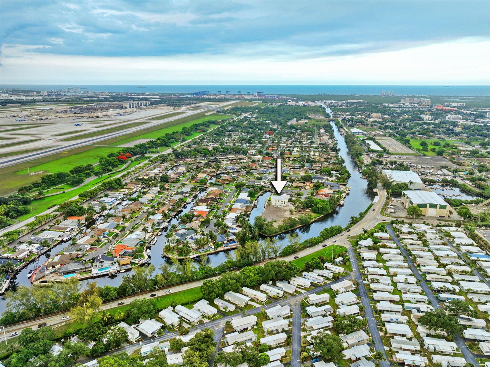 An aerial view shows a large house under construction next to a finished blue home — 1410 Florian Drive, Dania Beach FL 33004, DANIA BEACH, FL