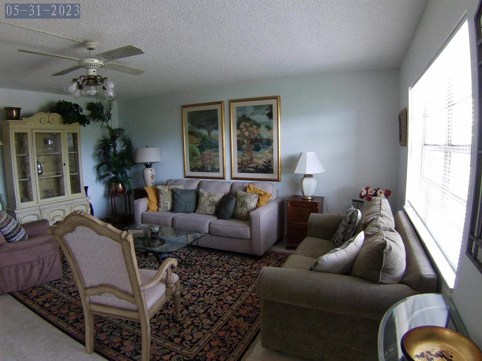 A living room features two sofas, a patterned area rug, and a large china cabinet — 865 Flanders S, Delray Beach FL 33484, DELRAY BEACH, FL