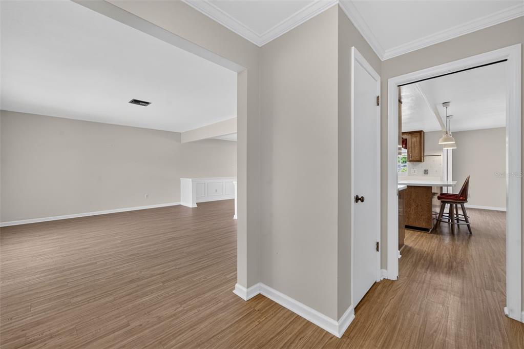 A view from a hallway looking into a living room and a kitchen — 125 E FAITH TERRACE, MAITLAND, FL