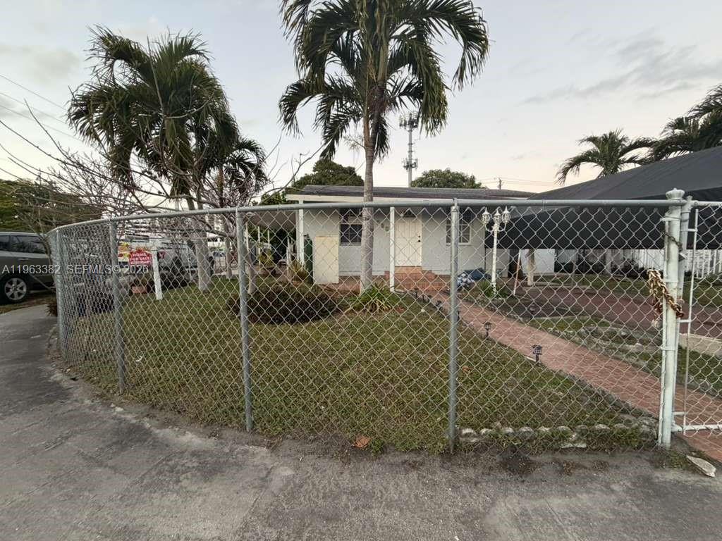 A single-story house with a chain-link fence and palm trees in the front yard — 501 SE 1st St, Hialeah FL 33010, HIALEAH, FL