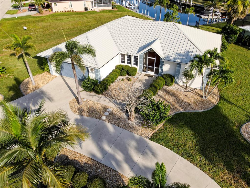 An aerial view of a single-story house with a metal roof and palm trees — 2500 RIO LISBO COURT, PUNTA GORDA, FL