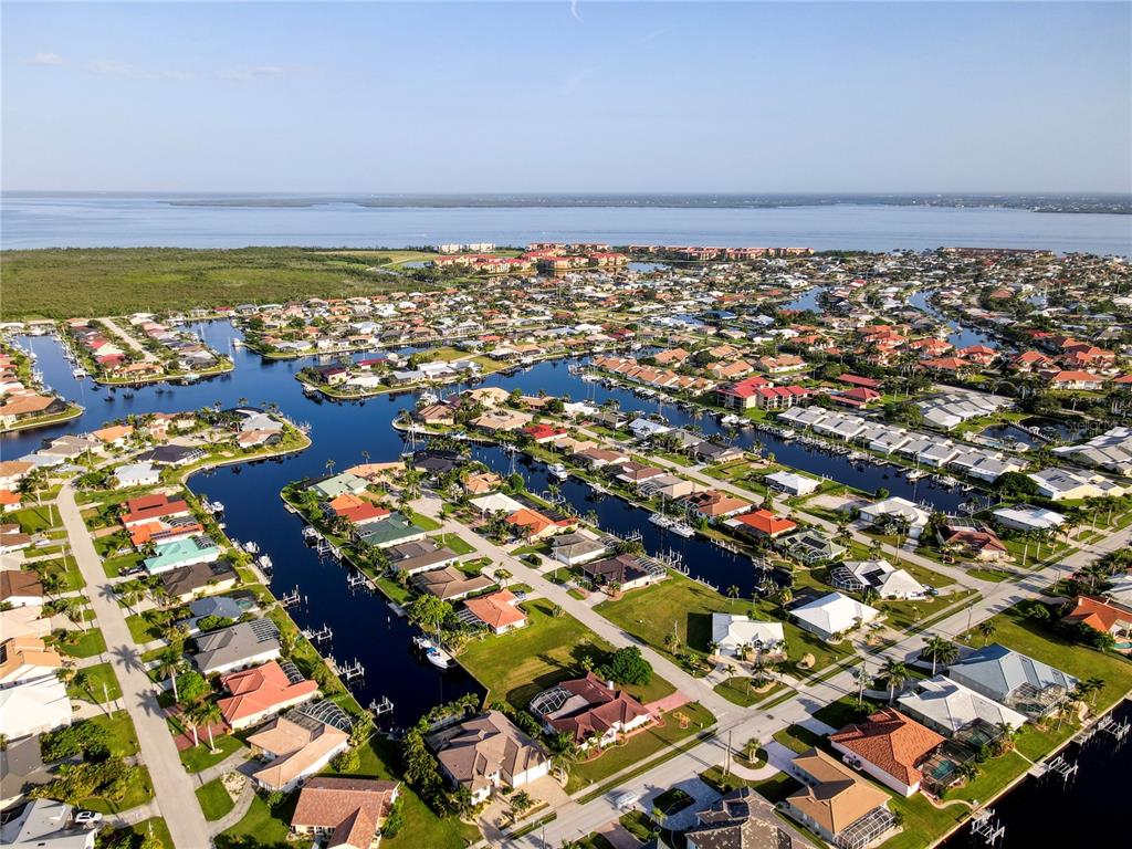 An aerial view of a waterfront residential neighborhood with canals and houses in Florida — 2500 RIO LISBO COURT, PUNTA GORDA, FL
