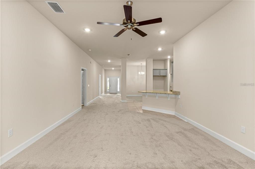 A kitchen with gray cabinets, granite countertops, stainless steel appliances, and a central island — 1667 ANN ROSE WAY, LEESBURG, FL