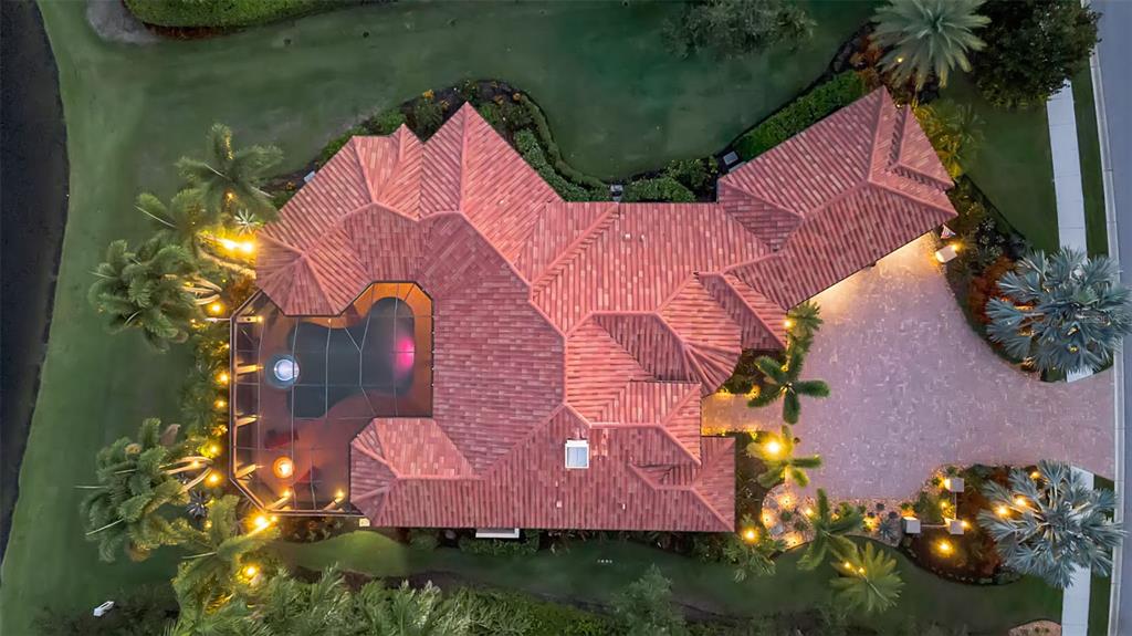 An aerial view of a house with a red tile roof, pool cage, and driveway — 15114 LINN PARK TERRACE, LAKEWOOD RANCH, FL