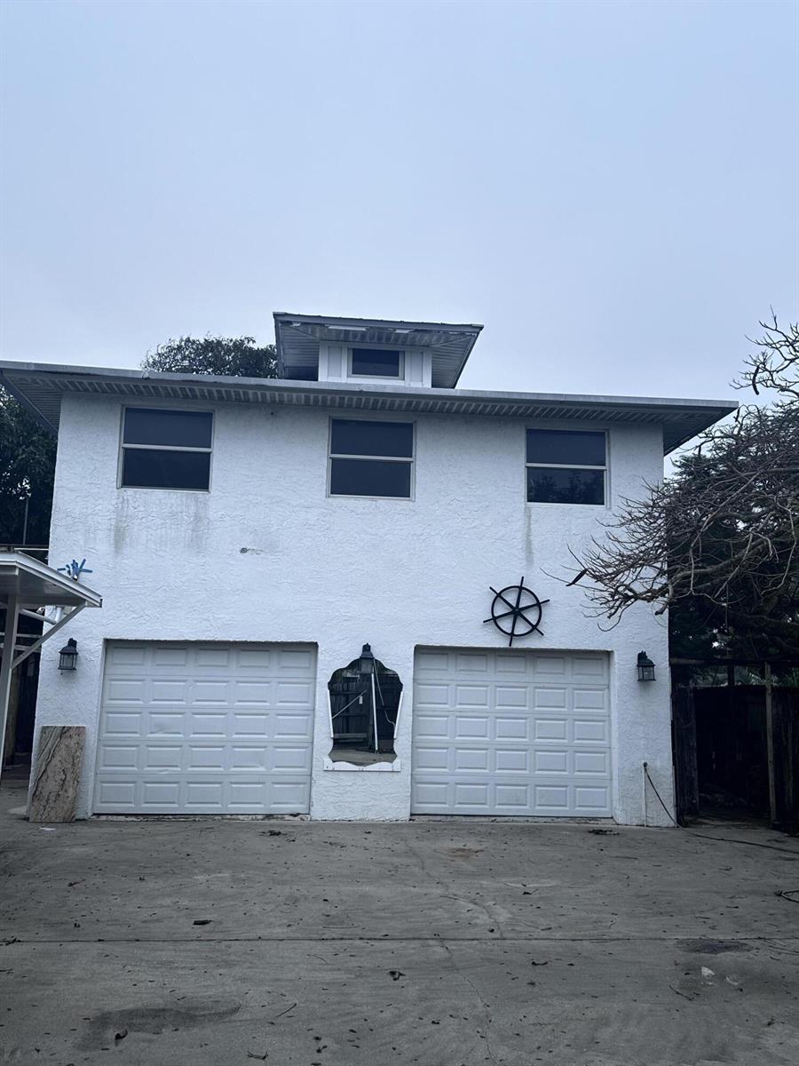 A two-story white stucco detached garage with two roll-up doors and a small cupola — 130 NE 4th Avenue, Boynton Beach FL 33435, BOYNTON BEACH, FL