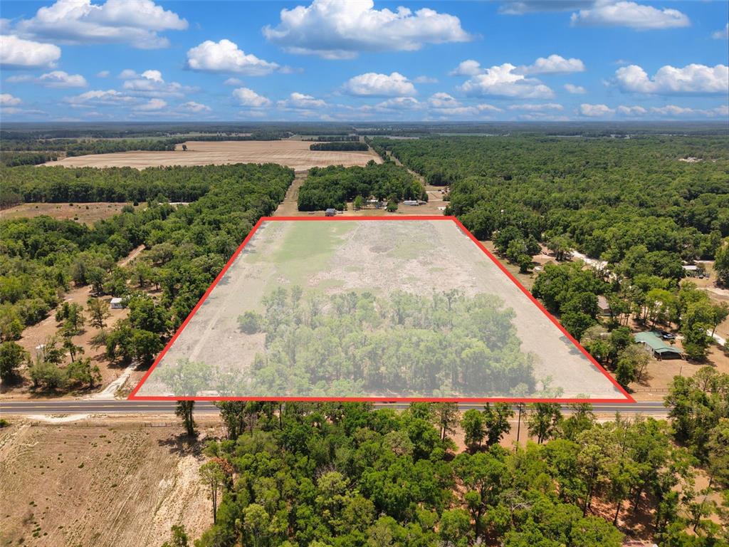 An aerial view shows a rectangular plot of land outlined in red along a road — 18 AC NW CR 138, BRANFORD, FL