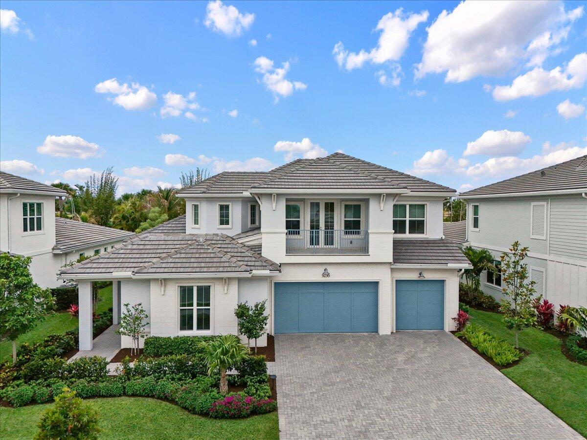 A two-story house with a white exterior, blue garage doors, and a tiled roof — 9236 Crestview Circle, Palm Beach Gardens FL 33412, PALM BEACH GARDENS, FL